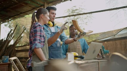 Team of carpenter working togethet in the furniture factory. Group of carpenter talking together for design woodcraft furniture at wood workshop. Carpenter and woodcraft concept
