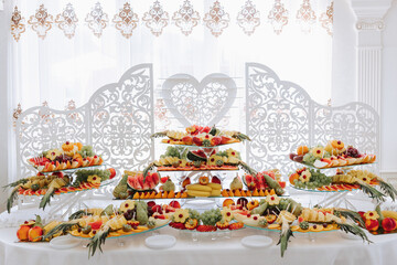 Fruit buffet for a wedding. Assortment of exotic fruits in the restaurant. Various compositions from fresh fruits.
