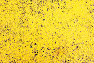 Yellow paint on black surface. Stucco wall texture. Yellow paint asphalt. Distressed noise backdrop...