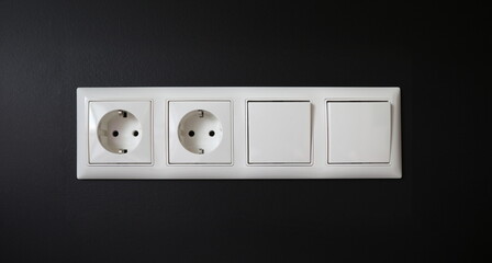 Integrated socket with switches installed in wall. Device is used to connect electrical appliances to network. Socket is grounded, which increases safety its use. Insulation damage