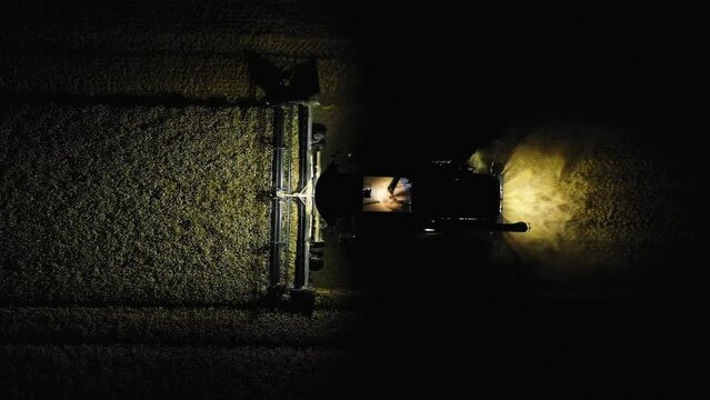 Combine working in the field at night