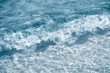 Foamy blue Sea waves background in the tropical, ocean