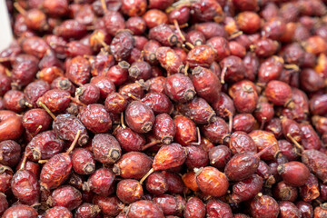freshly dried rosehip fruits at the herbalist,