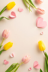 Fototapeta na wymiar For your beloved on Woman's Day: top view of delightful mix of tulips, and love hearts, showcased on a pastel beige canvas with space for text