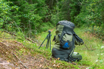 Obraz premium Tourist backpack and tripod on grass
