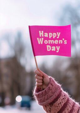 female hand holds a pink flag with the inscription Happy Women's Day, feminism, March 8, equality, holiday, demonstration, congratulation, fight for rights, street, text, lettering