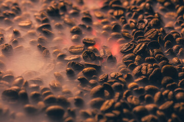 Roasted coffee beans with smoke and fire background. Close up,
