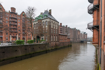 Naklejka premium Germany's second largest city Hamburg streets canals and symbolic buildings snow and colorful cloudy sky and daylight in winter