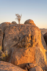 red sundown light on big Dolerite boulder in desert, near Hobas,  Namibia - obrazy, fototapety, plakaty
