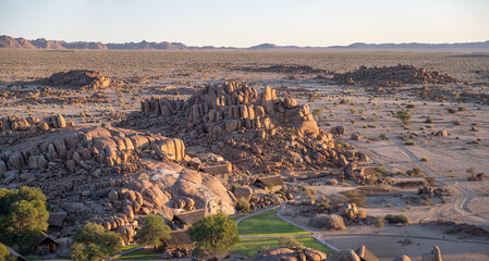 aerial with bungalows among Dolerite boulders at lodge in desert, near Hobas,  Namibia