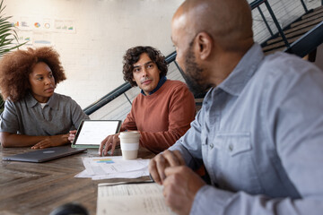 Team brainstorming ideas together in a casual meeting