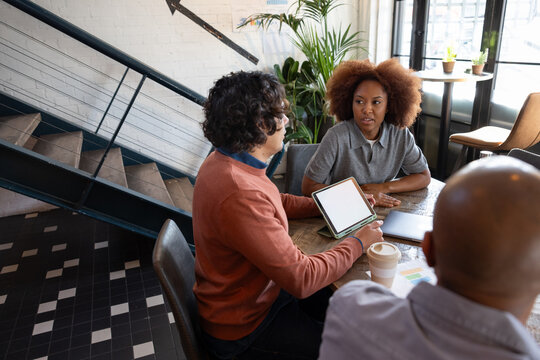 Team brainstorming ideas together in a casual meeting