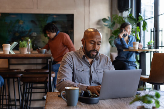 African American male freelancer working from a cafe