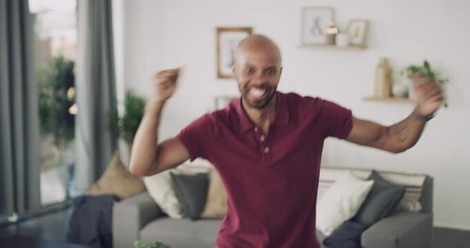 Black man, winner and happy for prize, dancing and excited with face, good news and living room. Energy, winning and wow for achievement, competition and fists for success, surprise and house