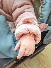 The newborn baby's hand reaches out as if trying to hold something 