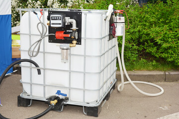 Portable fuel tank with pipes, pump and measuring meter. Mini portable diesel storage tank station.