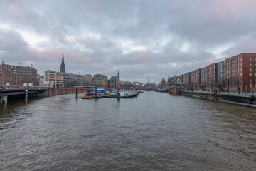 Fototapeta na wymiar Germany's second largest city Hamburg streets canals and symbolic buildings snow and colorful cloudy sky and daylight in winter