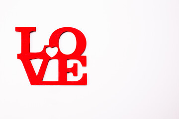 The word love in wooden red letters on white background. Valentine's day, Mother's Day, March 8 holiday card concept