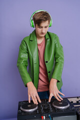  Young DJ playing at the turntable