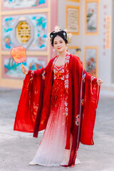 Fototapeta premium Woman dress China New year. portrait of a woman. person in traditional costume. woman in traditional costume. Beautiful young woman in a bright red dress and a crown of Chinese Queen posing.