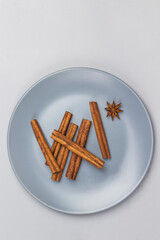 Cinnamon sticks and star anise in gray ceramic plate