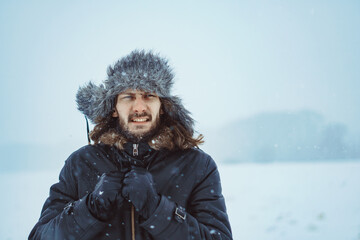 Fototapeta na wymiar a bearded man in an earflap in winter