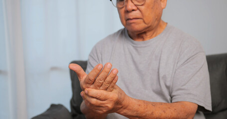 Asian man has tingling and numbness in his hand which causes beriberi. - obrazy, fototapety, plakaty
