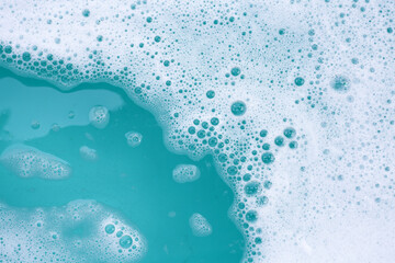 Detergent foam bubble on water. Blue background, Soap sud