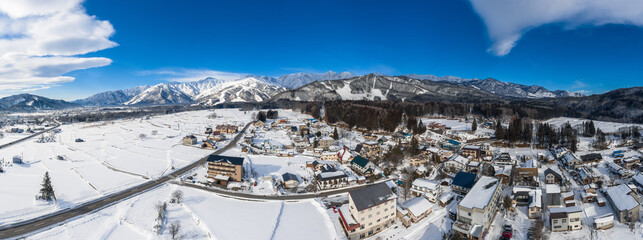 Hakuba, Japan in Winter with. mountains in the background - aerial drone panorama photo