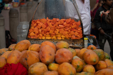 Varanasi India 8 December 2023, Selling papaya fruit and papaya fruit salad in glass on a cart at...