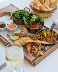Colorful Spanish food assortment, with fish, paella and vegetables 