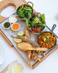 Colorful Spanish food assortment, with fish, paella and vegetables 