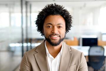 A close-up portrait of a businessman in a light suit, capturing his confident smile and engaging...