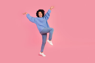 Full body photo of attractive young woman raise hands celebrate dressed stylish blue knitwear...