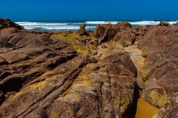 Picturesque coastal red rocks on the Atlantic Ocean coast.Legzira beach ( ore Gzira).  Morocco,...