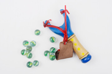 Wooden and rubber slingshot with marble bullets, traditional children's toy
