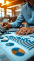 Fototapeta premium Businessman analyzing financial data and graphs on desk in office.