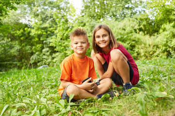 Fototapeta premium Portrait of smiling boy and girl at park