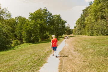 Disabled boy walking on footpath at park