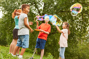 Kids playing with bubbles at park