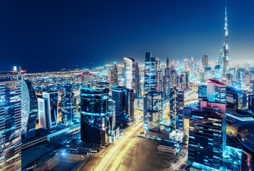 Nighttime skyline of Dubai, United Arab Emirates. Rooftop view.
