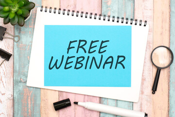 FREE WEBINAR on blue paper composition with stationery on color background. idea of providing educational online session without charge, conveying an opportunity for learning and skill development