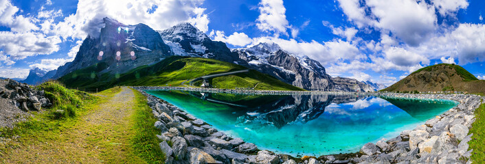Switzerland nature .  panoramic view of Fallboden lake with turquoise water and reflections of snowy peaks. Kleine Scheidegg mountain pass famous for hiking in Bernese Alps. Swiss travel - 723813138