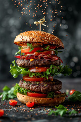 Delicious burger with flying ingredients on dark background