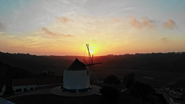 Beatiful aerial view with sunset in Portugal with old windmill and mountains