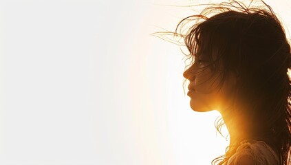 Silhouette of a beautiful woman with wind blowing her hair. - obrazy, fototapety, plakaty