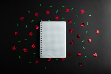 top view photo of notebook, writing in spiral notepad letter to santa on isolated black background with copyspace. Concept happy new year, merry Christmas, valentines day.