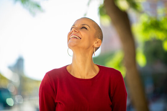 older woman with shaved head laughing