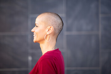 profile portrait woman with shaved hair smiling