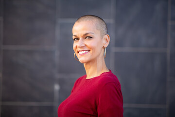 smiling woman with short shaved hair